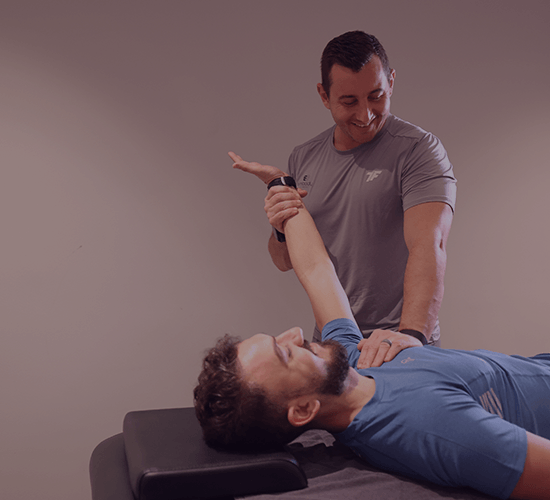 massage therapist stretching member's arm